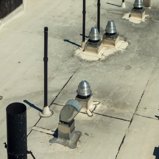 Commercial roof vents with residues illustrating exposure to vegetable oils and fats.