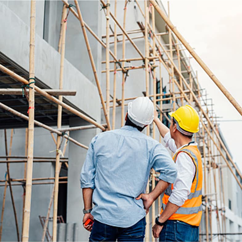 Two professionals reviewing an installed Exterior Wall System.