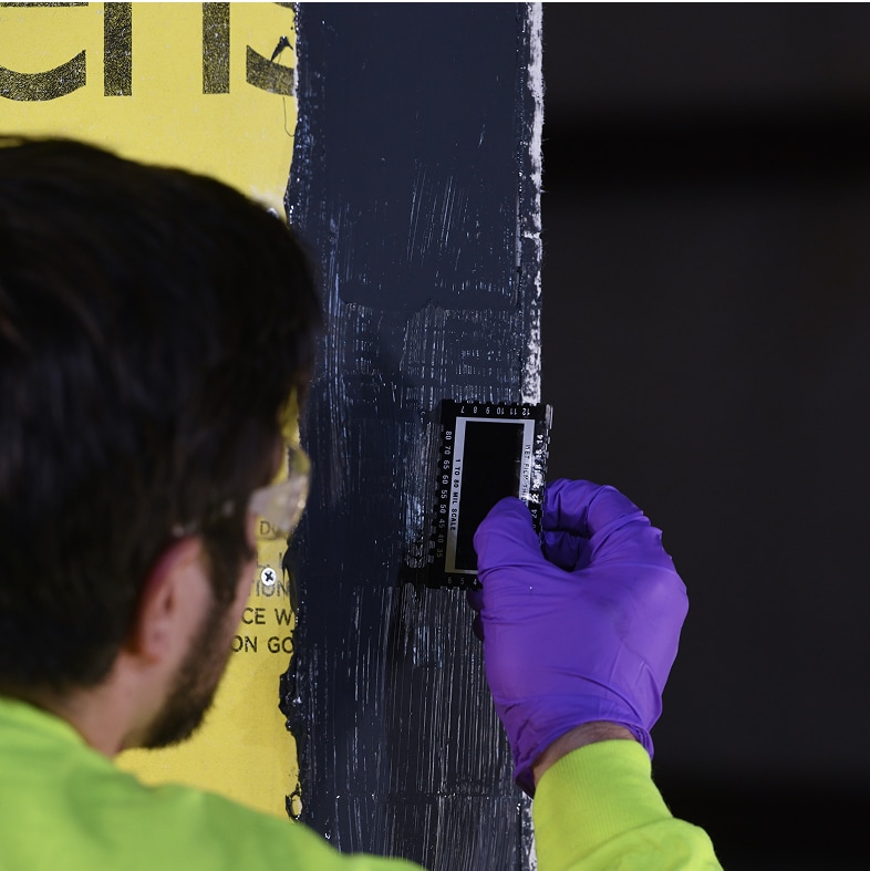 Thickness measurement of WALLcontrol™ modified silicone STPE VP liquid flashing applied to a commercial wall.