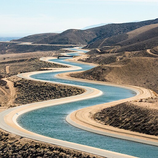 Aerial view of the winding California Aqueduct, showing water supply and Teranap Geomembrane application in the desert.