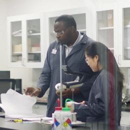 Two lab technicians working in a Siplast lab.