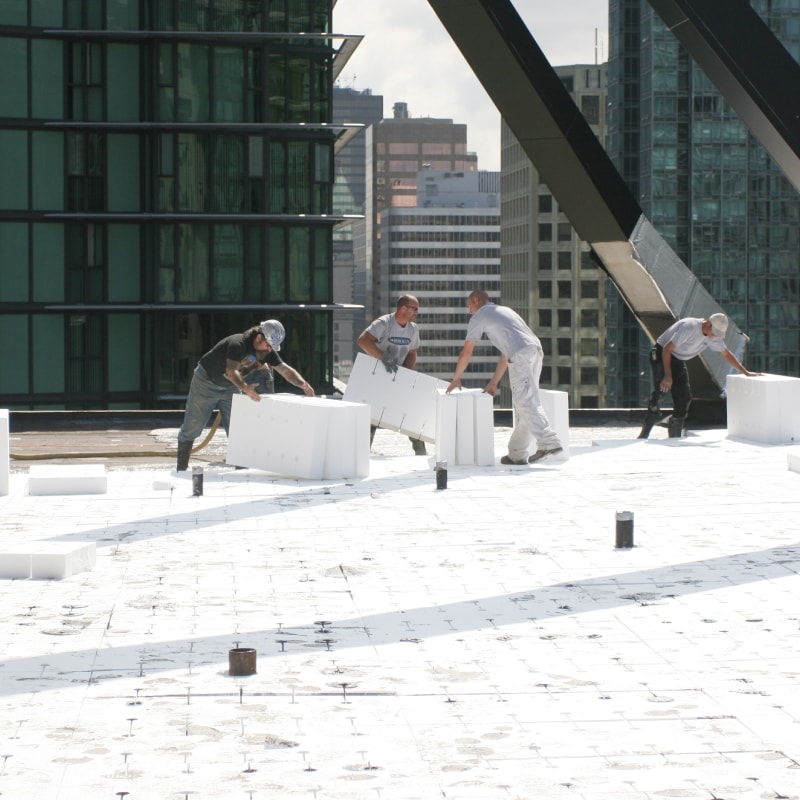 Roofers installing Insulperm Insulation Boards