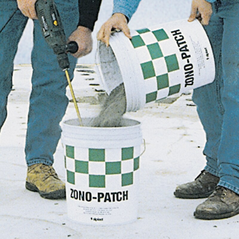 Contractors pouring Zono-Patch binders in buckets