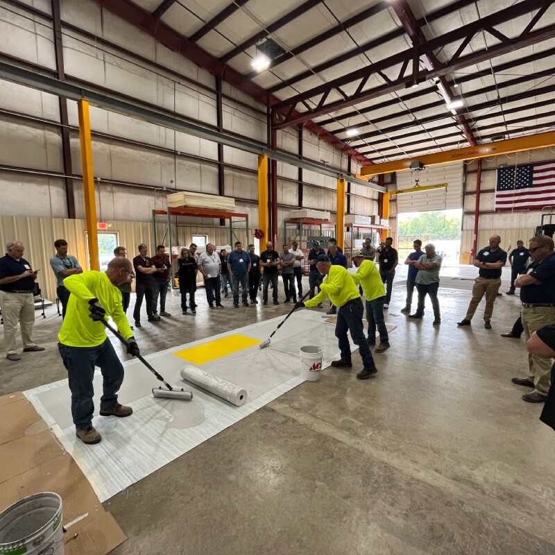Siplast employees testing materials at Gum Springs resin plant