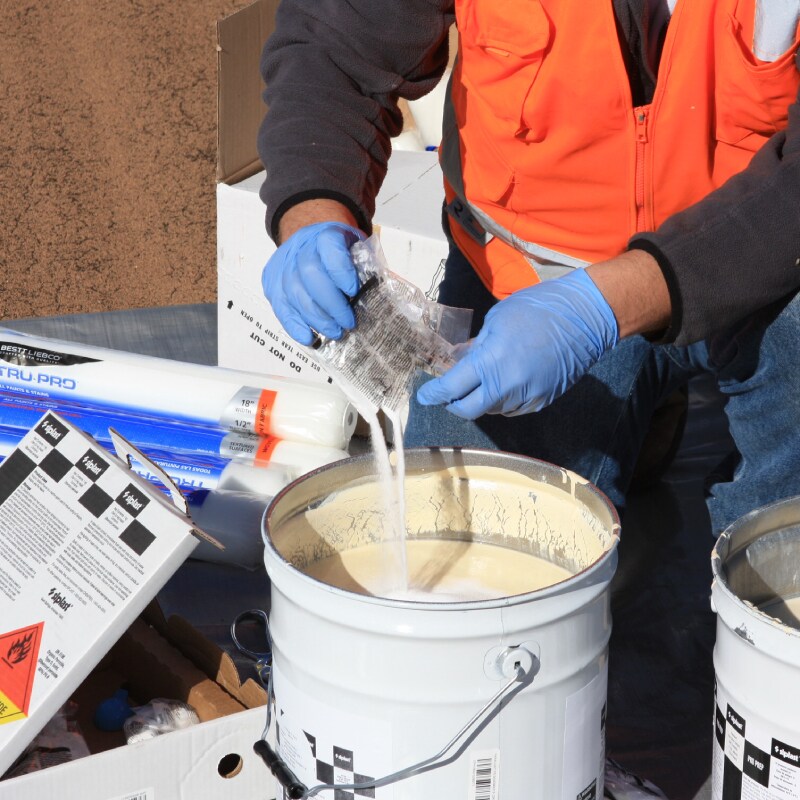 Contractor mixing Siplast Pro Catalyst