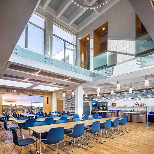 Modern school cafeteria and mezzanine representing durable SBS roofing solutions for educational facilities.