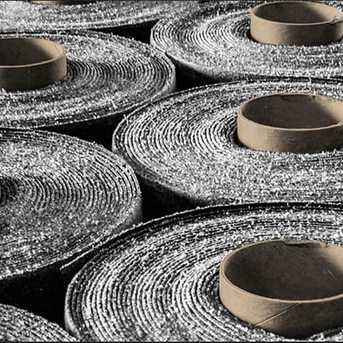 Rolls of Siplast SBS-modified bitumen roofing membranes with factory-embedded RoofTag radio frequency chips.