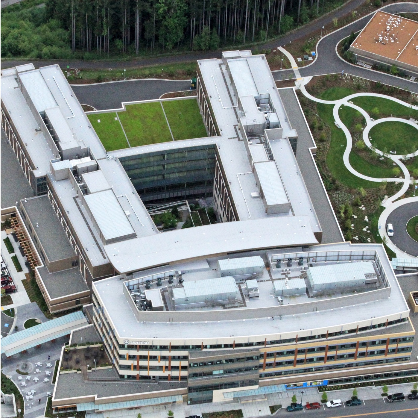 Aerial view of Swedish Hospital, showing its large building complex, expansive green roofs, and surrounding landscape.