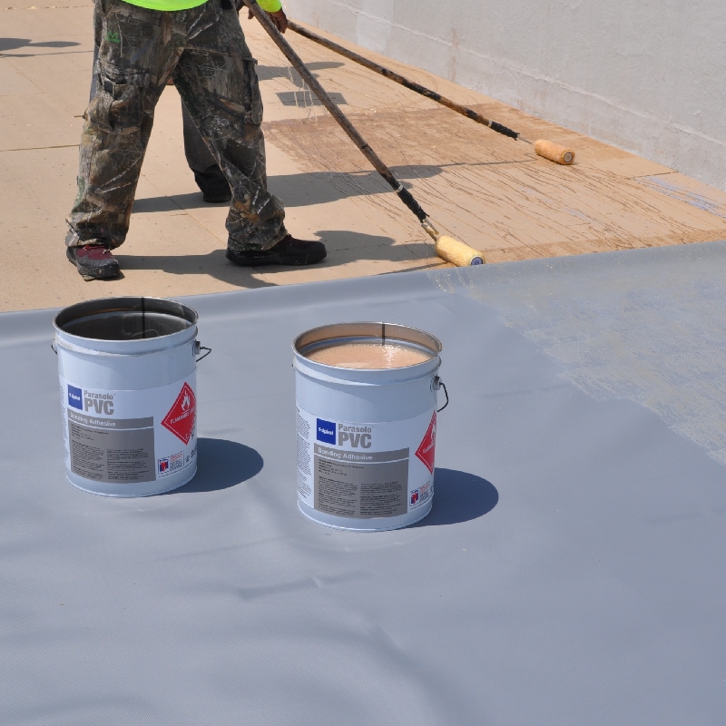 Commercial roofing contractors rolling on Siplast single-ply roof liquid materials