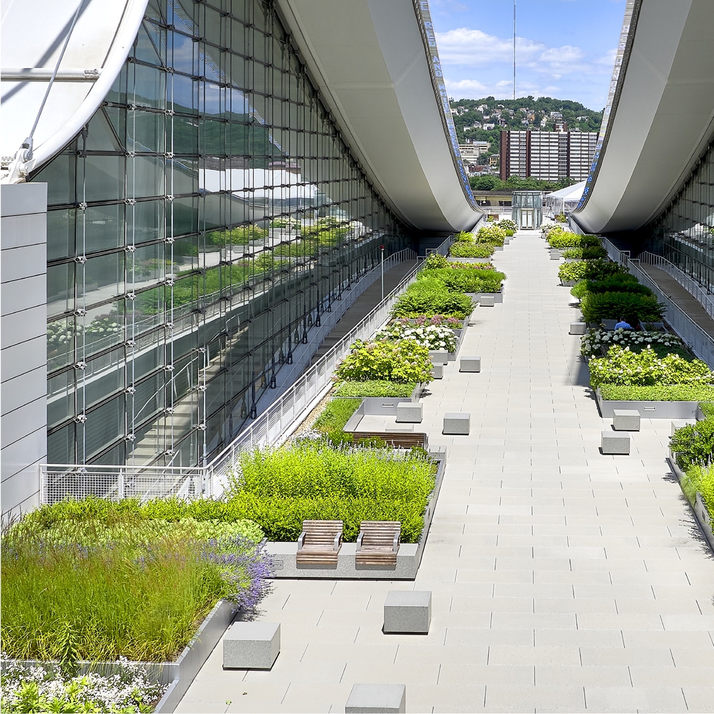 Green roof terraces and landscaped pathways between the striking glass and steel structures of the David L. Lawrence Convention Center, showcasing Siplast products on modern building design.