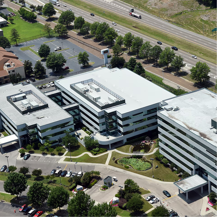 Aerial view of a commercial office complex featuring an SBS-modified bitumen low-slope roofing system.