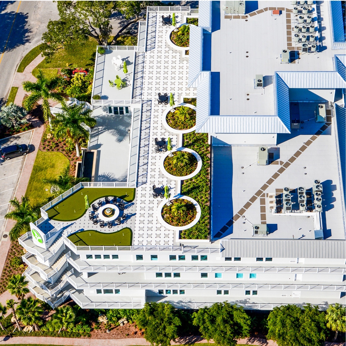 Aerial view of a commercial building with vegetated overburden and green roof sections, showcasing sustainable and aesthetic roofing solutions.
