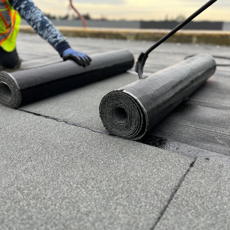 Contractor using torch to apply SMS Modified Bitumen