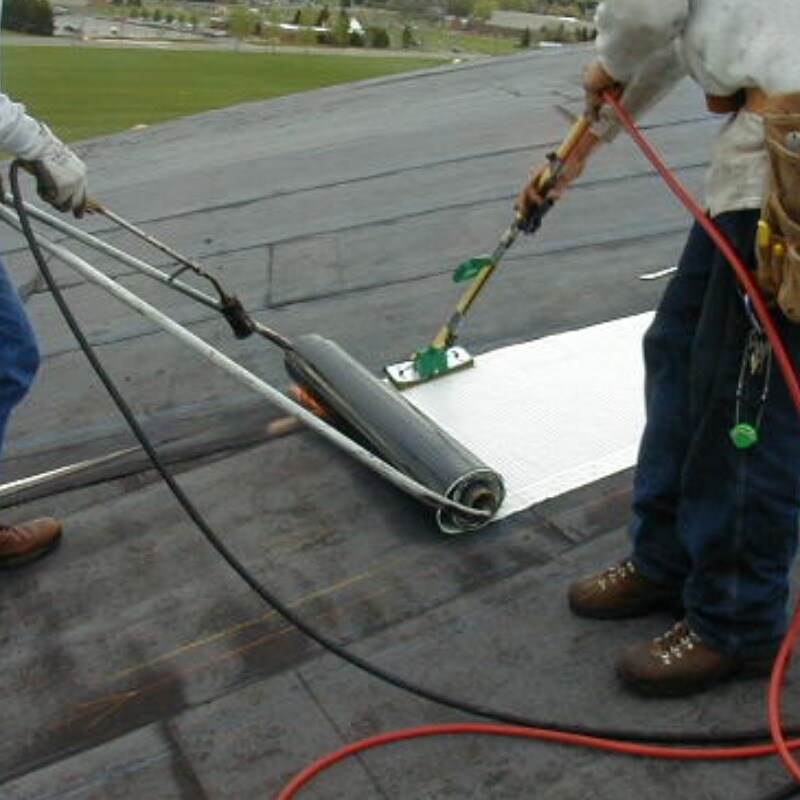 Roofers applying sbs-modified asphalt materials