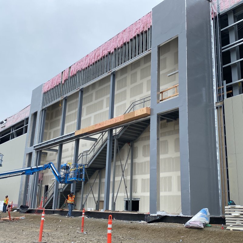 A commercial building under construction, featuring WALLcontrol™ air and water barrier systems on the exterior walls.
