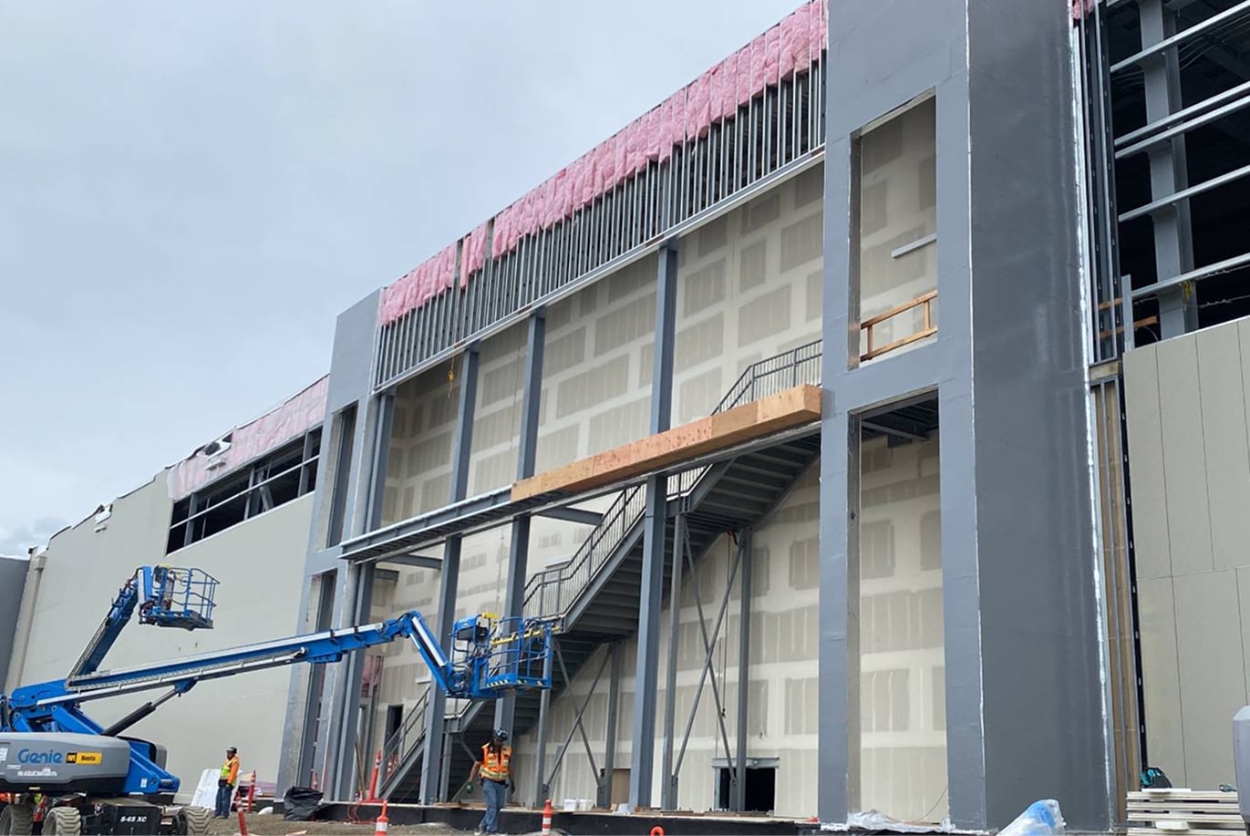 Exterior of a large commercial building under construction showcasing Siplast building enclosure application.