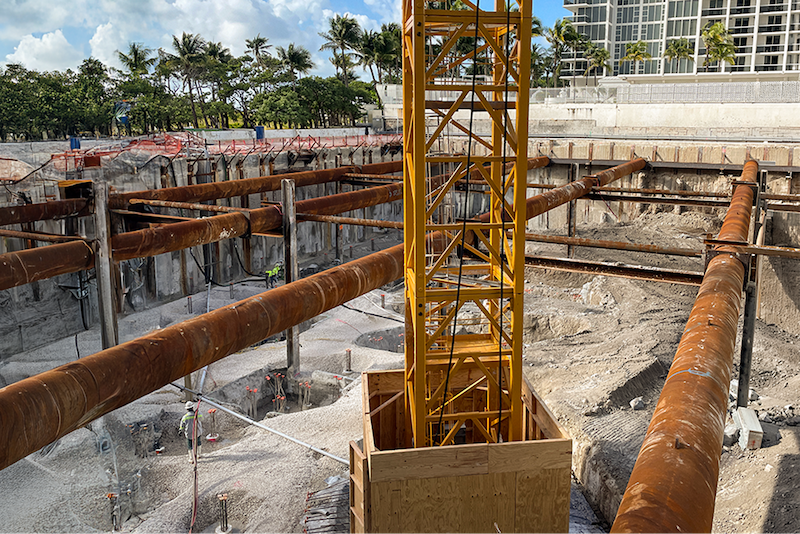 Below-grade waterproofing systems excavation site featuring an earth-retention system.