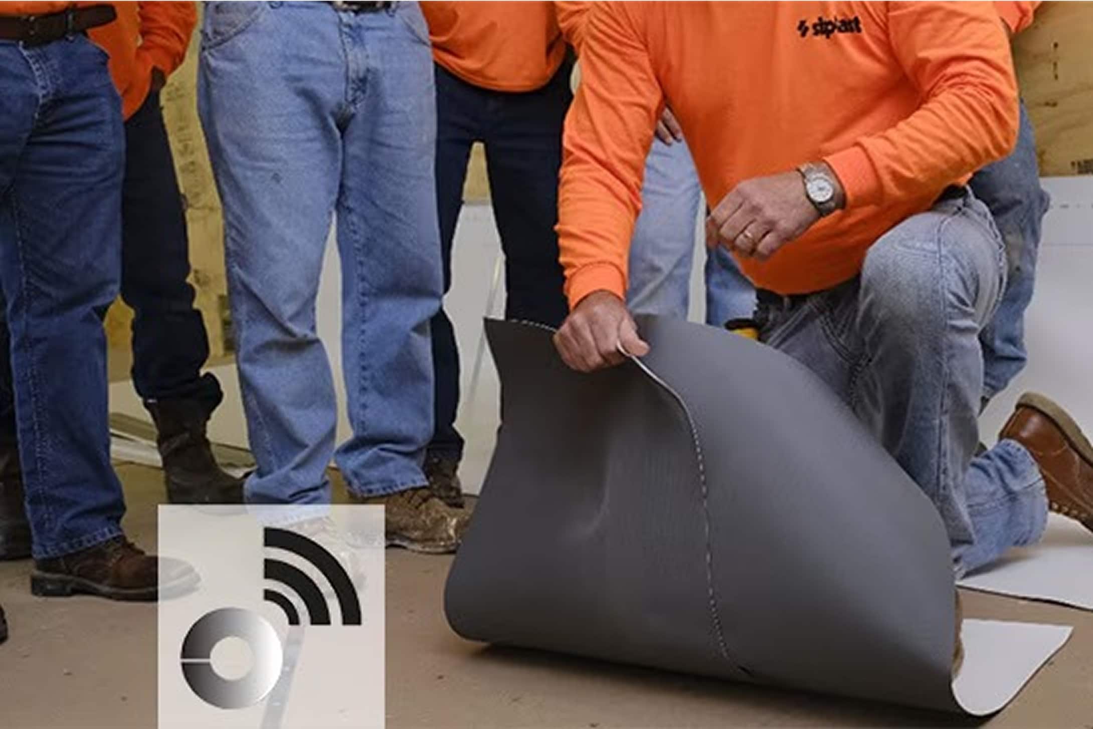 A Siplast RoofTag being embedded into an SBS-modified bitumen membrane by a roofer, demonstrating the technology for roof asset identification and Certificate of Analysis.