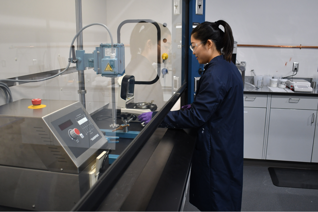 Siplast lab technician performing quality control testing on roofing materials.