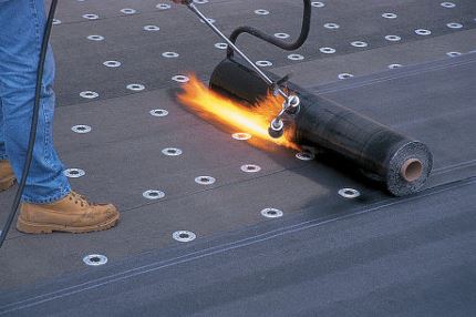 installation of a torch-applied rolled roofing sheet