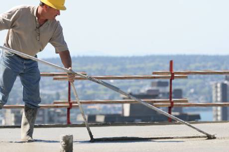 Siplast worker rolling SBS-modified bitumen membranes