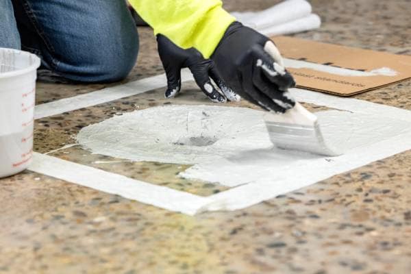 Contractor brushing on Terapro Flashing Resin