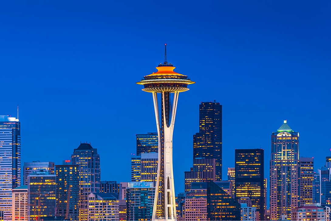 The Seattle skyline at night, featuring the Space Needle, representing high-performance Siplast waterproofing solutions.