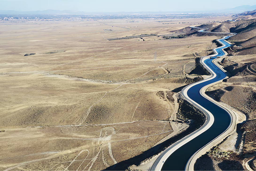 Aerial view of a long concrete irrigation canal through California.
