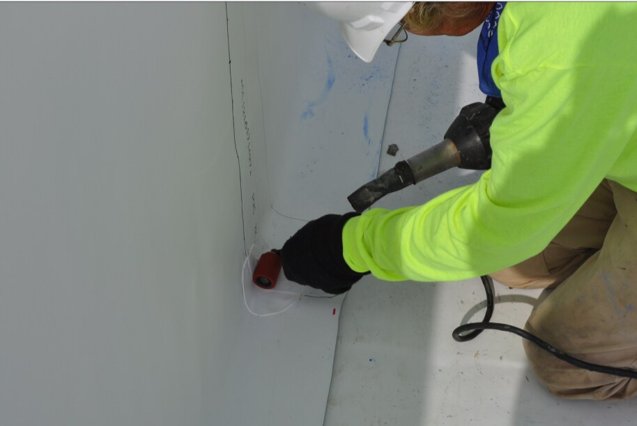 Man performing commercial roof repair and maintenance