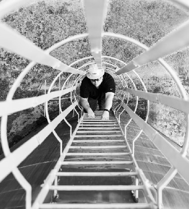 Siplast employee climbing ladder