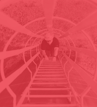 Siplast worker in a hard hat climbing a safety ladder.