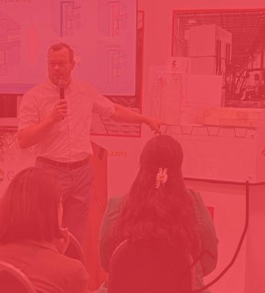 Abstract red image overlaying people attending a Siplast seminar, representing networking and learning at Upcoming Events.