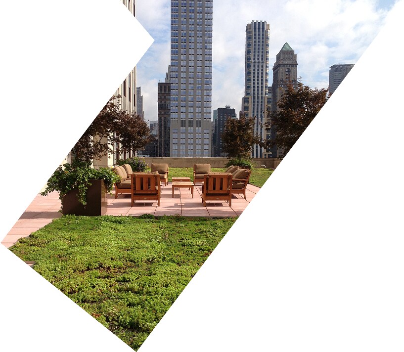 Urban rooftop terrace with lounge chairs and city buildings