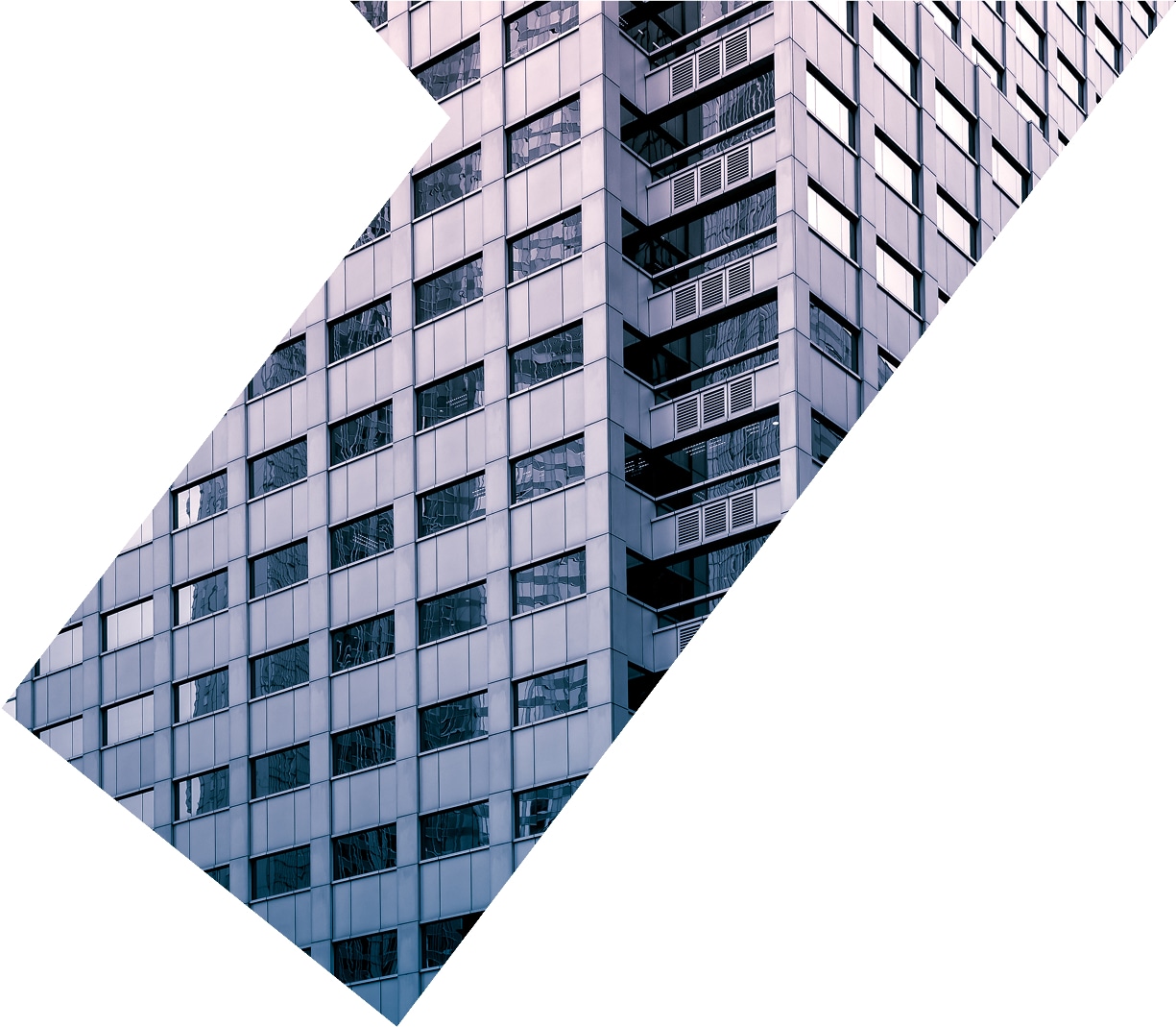 Large building wall with reflective windows showing nearby skyscrapers.