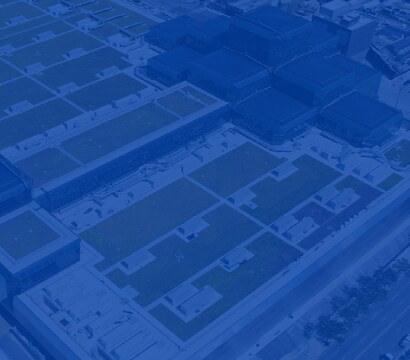 Abstract blue image overlaying an aerial view of commercial rooftops, representing Siplast's presence at industry events.