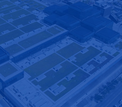 Abstract blue image overlaying an aerial view of commercial rooftops, representing Siplast's presence at industry events.