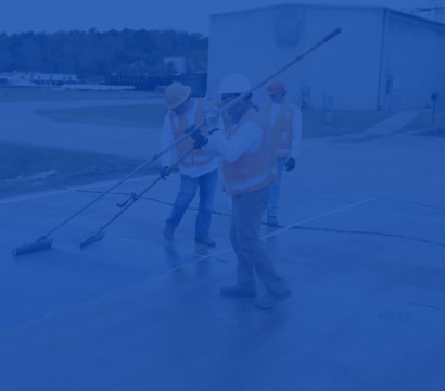 Construction team applying coating.