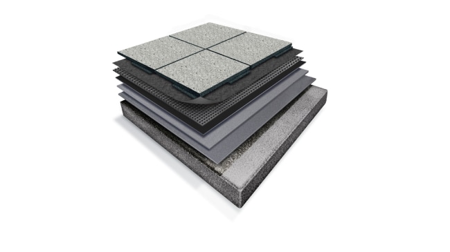 Layered diagram of a Siplast roof system with gray rubber paver tiles on top