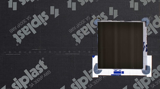 Full wall installation of Siplast SA 300VP AWB membrane around a window opening.