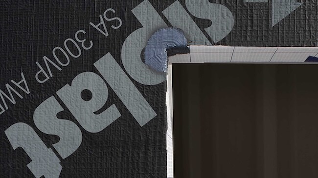 Close-up of a window corner detail featuring Siplast liquid flashing over the self-adhered barrier.