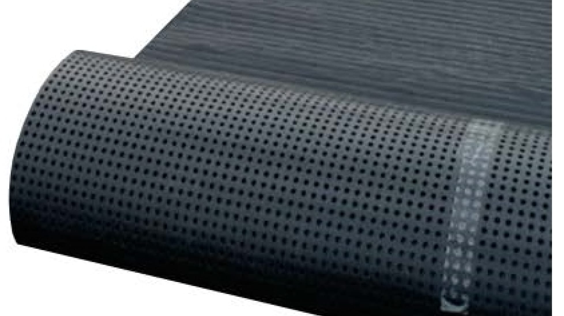 A roll of black, perforated drainage mat, used for effective below-grade water management.