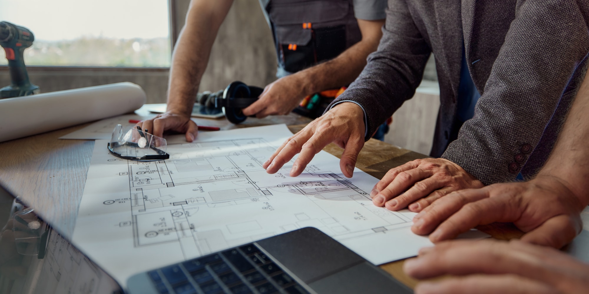 Architects and design professionals review blueprints on a table, representing Resources for Design Professionals and technical guidance.