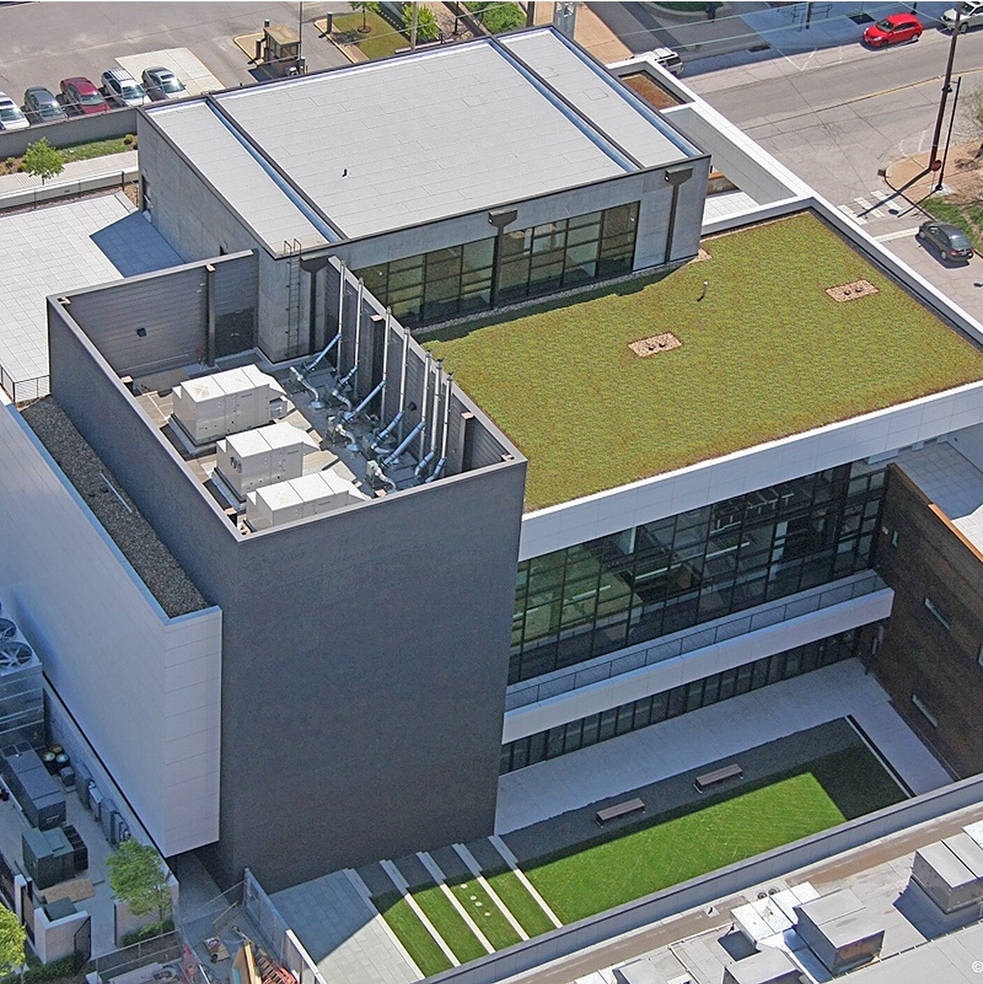 Aerial view of the Hardesty Arts Center, showcasing its modern architecture, prominent green roof, and outdoor turf courtyard.