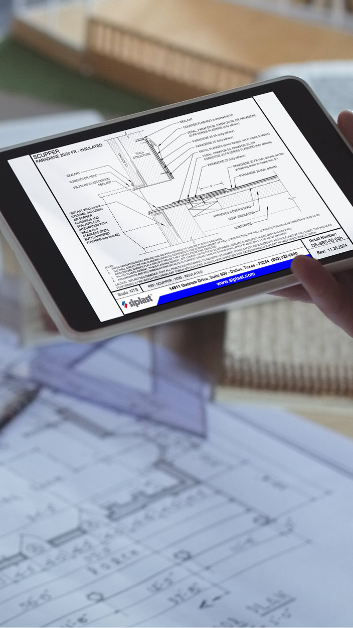 Digital tablet displaying a Siplast architectural detail drawing for an insulated roof scupper assembly over printed blueprints.