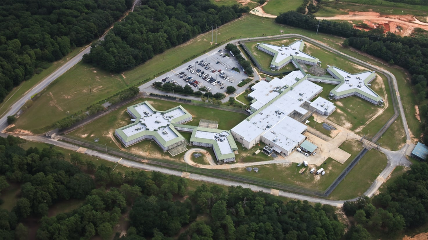 Aerial view of the large Dougherty County Jail complex, showcasing a complex, phased reroofing project profile.