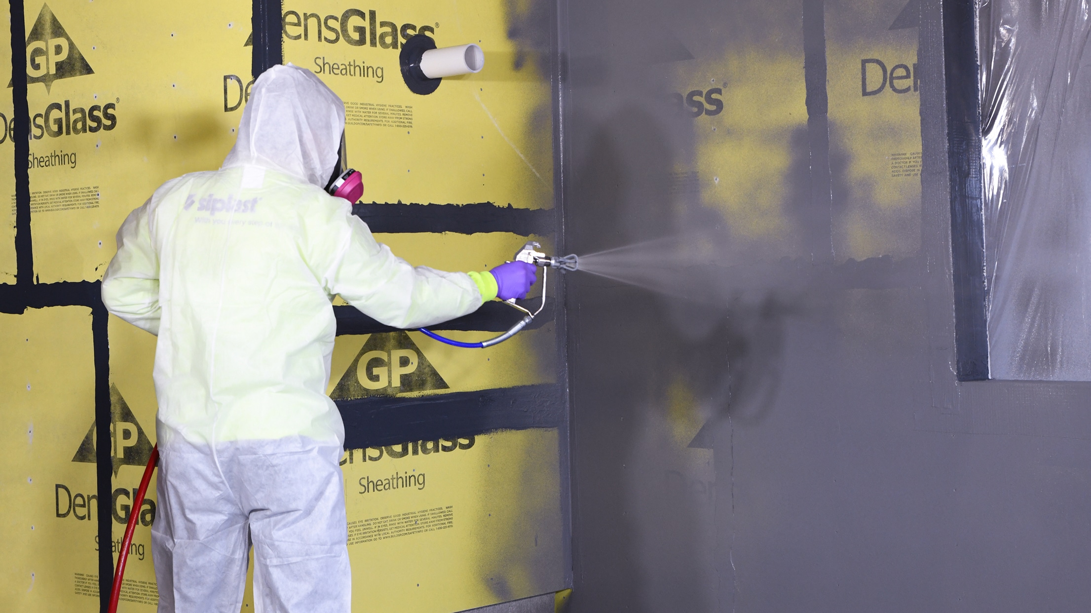 WALLcontrol™ modified silicone VP liquid AWB application on a building wall.