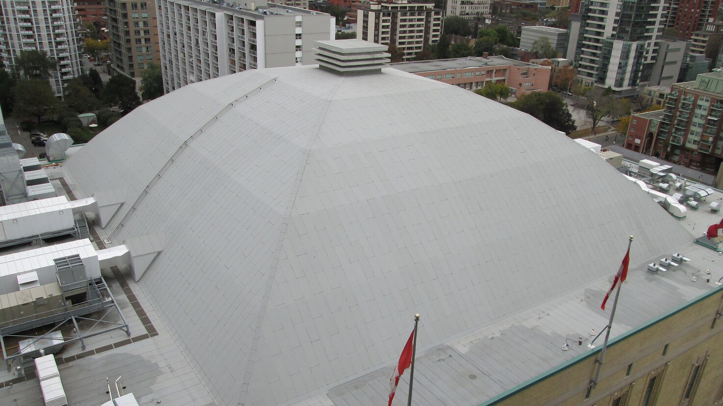 Aerial view of the large white dome roof of Maple Leaf Gardens in Toronto, showcasing a roofing preservation project.