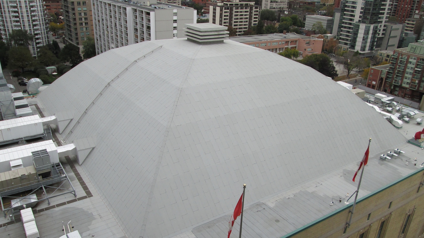 Aerial view of the large white dome roof of Maple Leaf Gardens in Toronto, showcasing a roofing preservation project.
