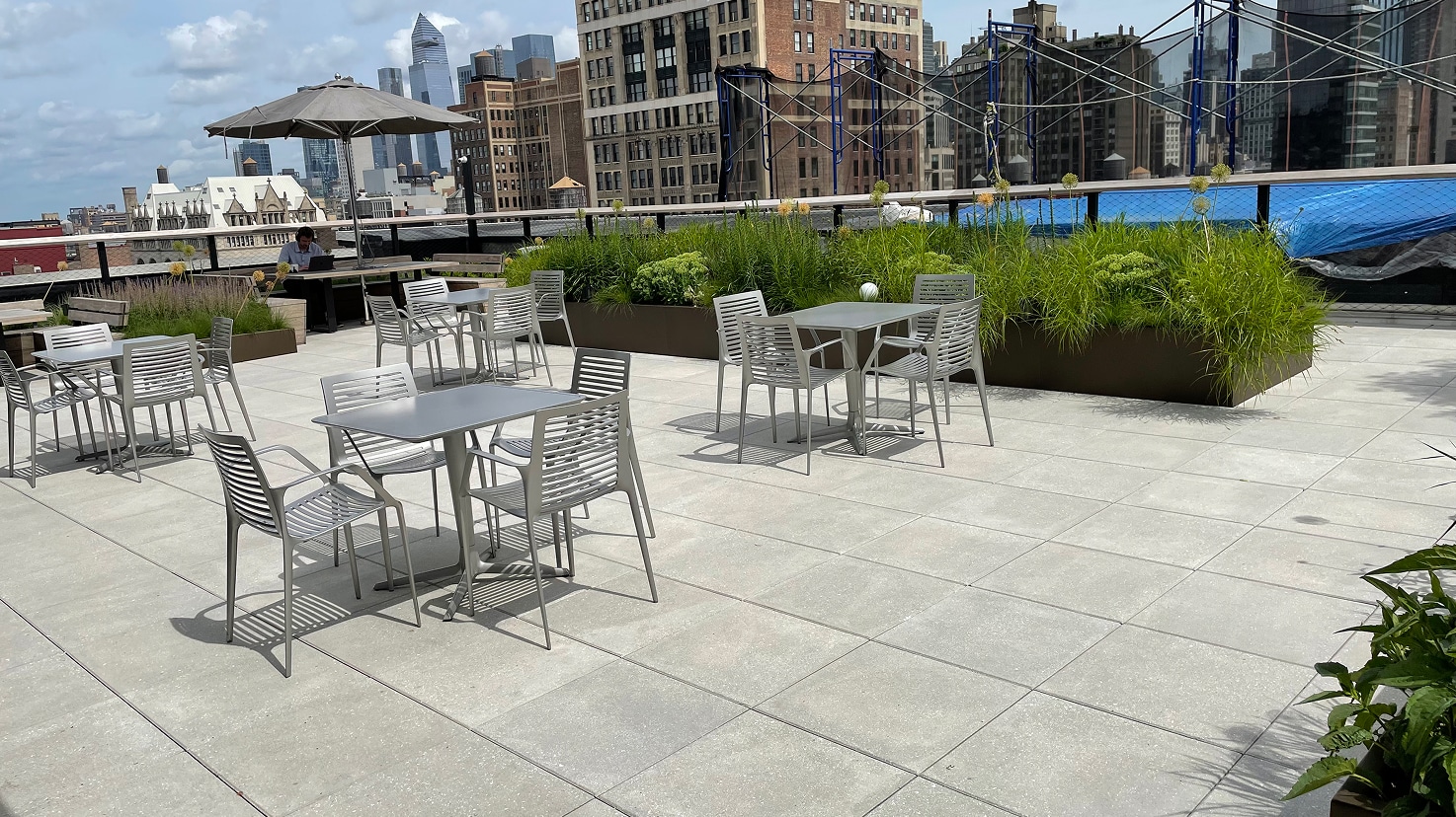 Amenity space design with easy access for maintenance, featuring pavers and greenery