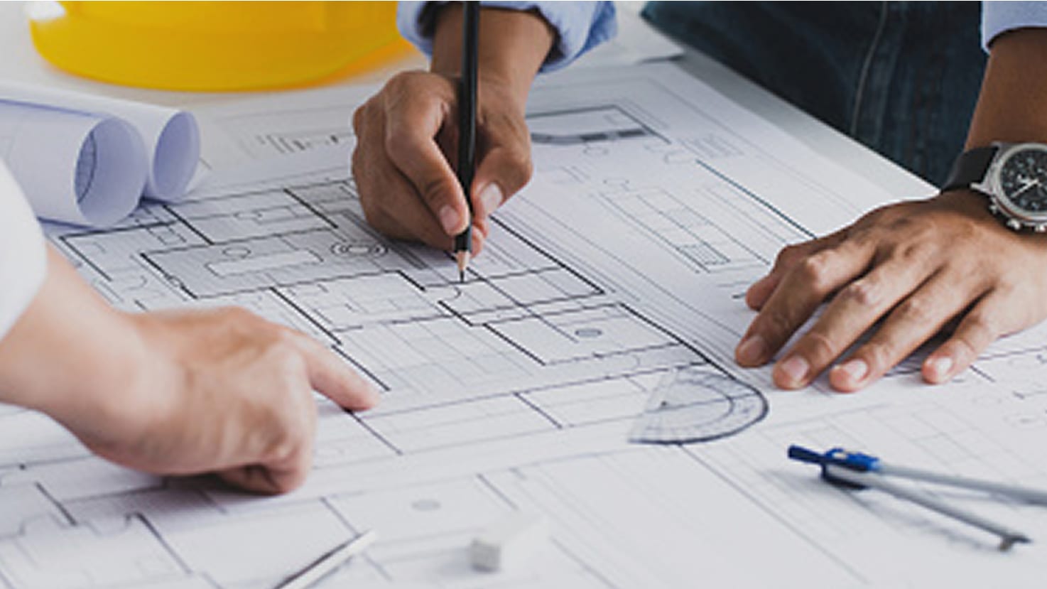 Collaborative architectural design process: team working on building blueprints
